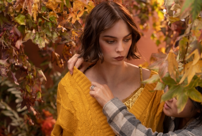 Change of Pace model in orange dress walking through Autumn backdrop