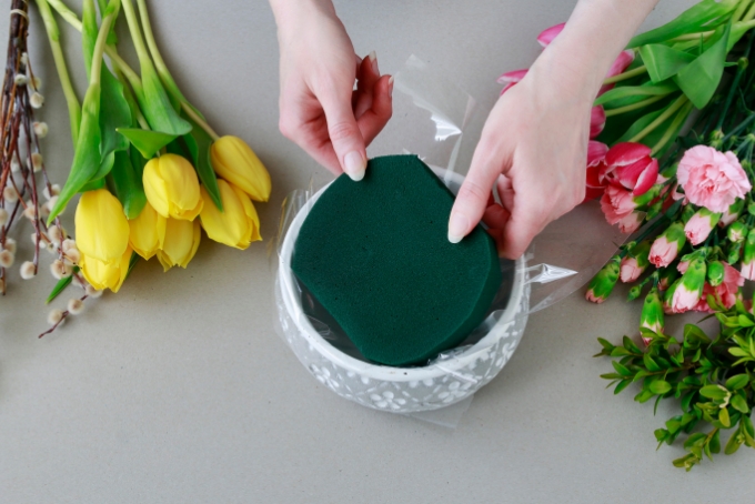 floral foam in a vase with yellow tulip and other flowers